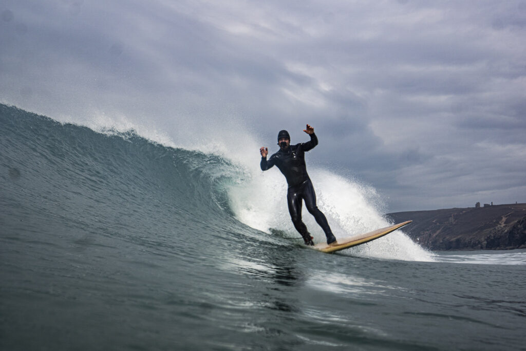 James Otter surfing a sustainable, hollow wooden surfboard