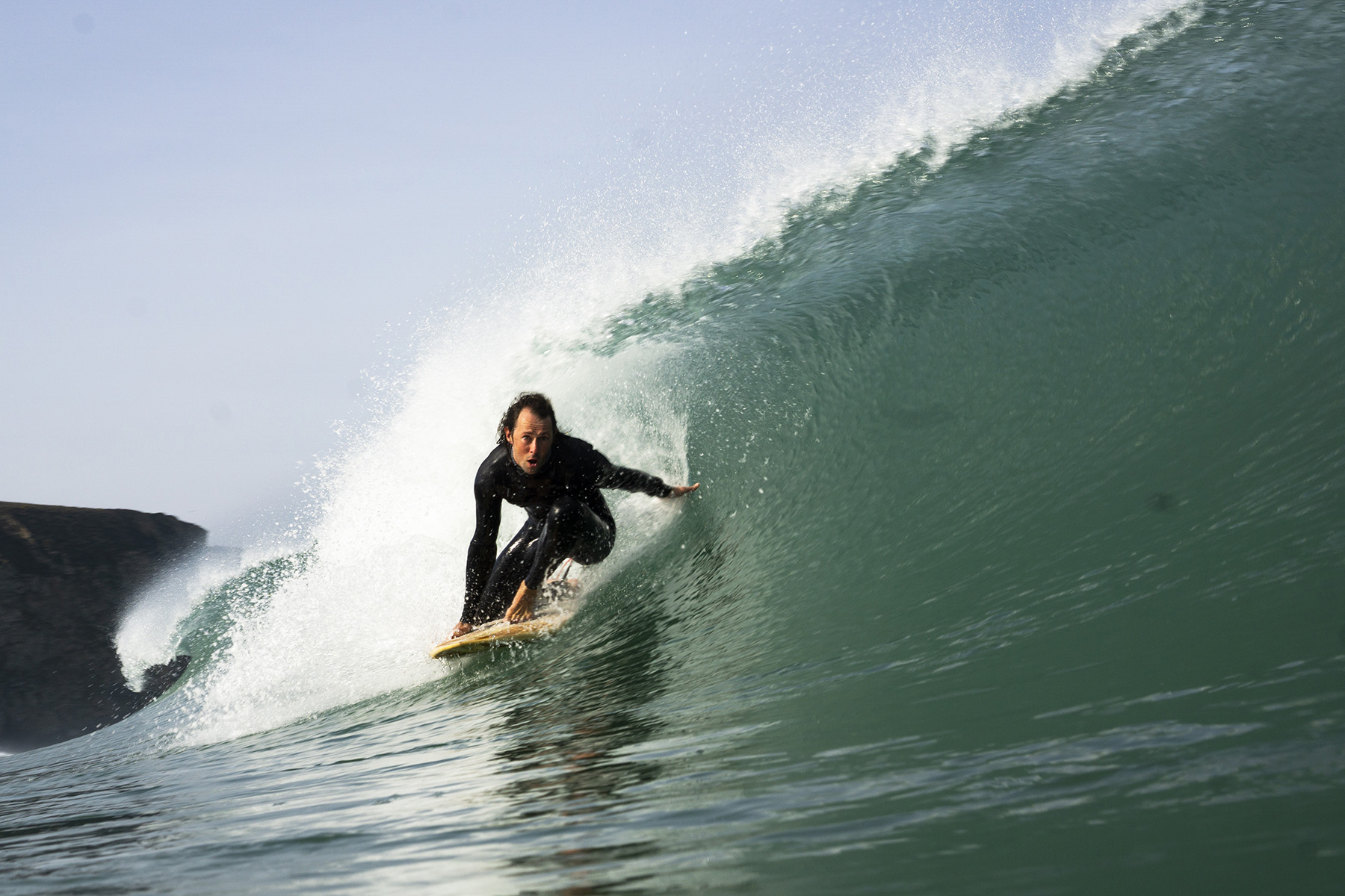 surfing a sustainable, hollow wooden surfboard by Otter Surfboards