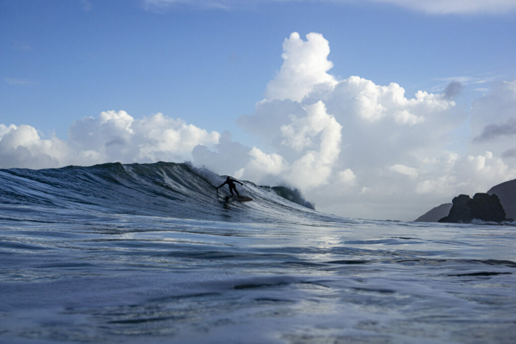 Surfer on a Sustainable, Hollow Wooden Surfboard in Cornwall, UK Otter Surfboards