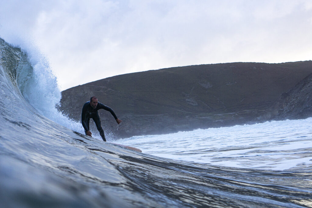 Surfer on a Sustainable, Hollow Wooden Surfboard in Cornwall, UK Otter Surfboards