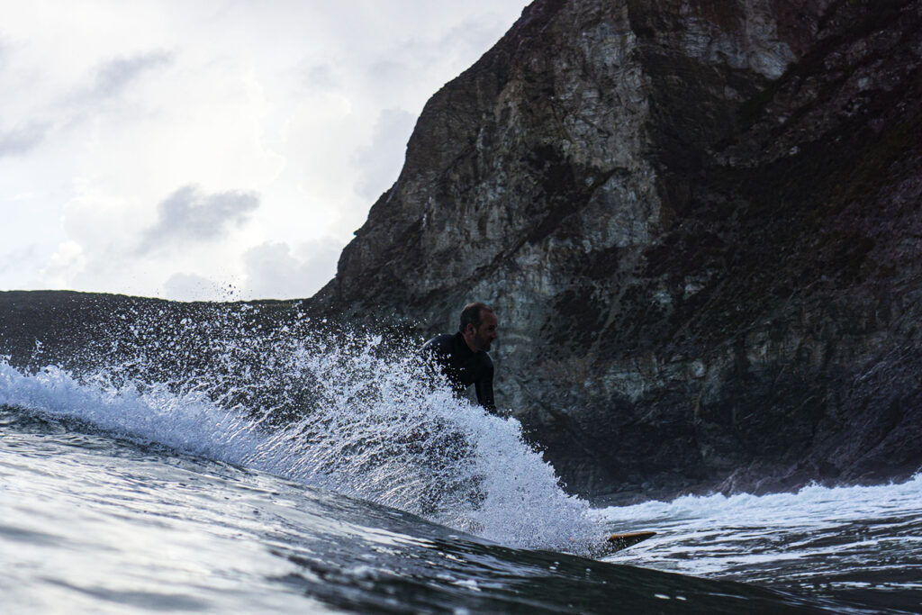 Surfer on a Sustainable, Hollow Wooden Surfboard in Cornwall, UK Otter Surfboards