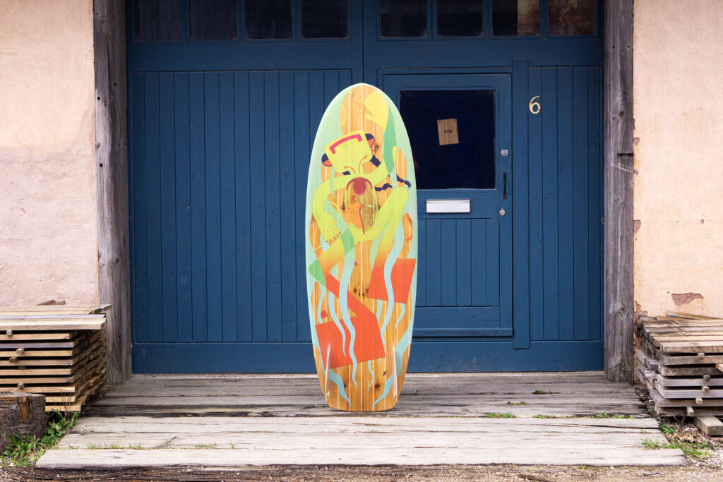 Sustainable, hollow wooden surfboard featuring artwork by Christina Barrera