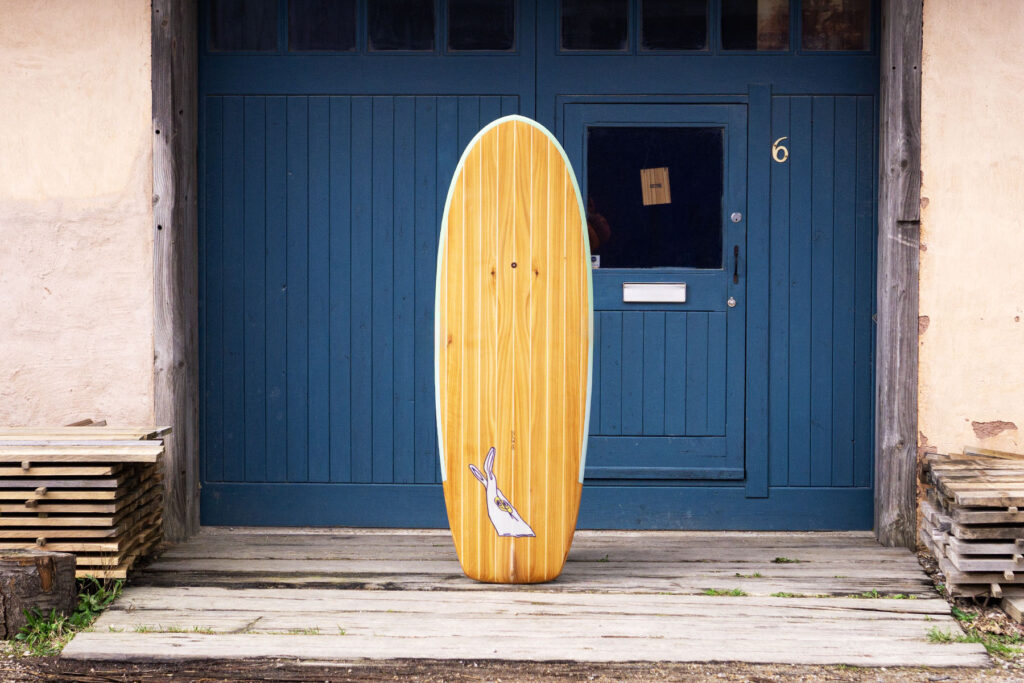 Sustainable, hollow wooden surfboard featuring artwork by Christina Barrera
