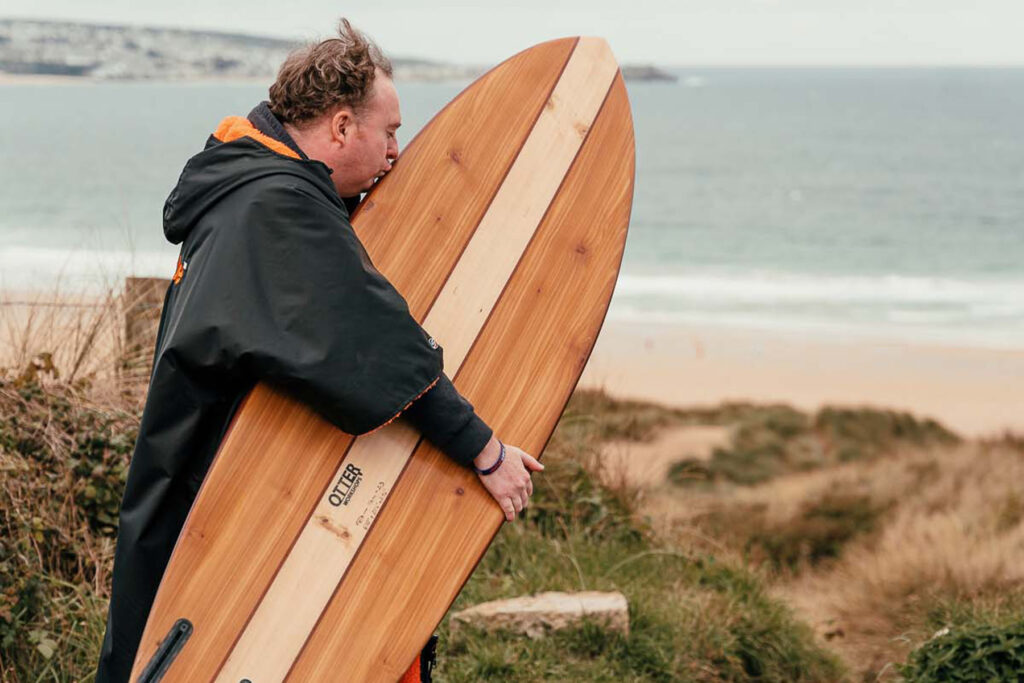 Otter Surfboards - Rich with his hollow wooden surfboard