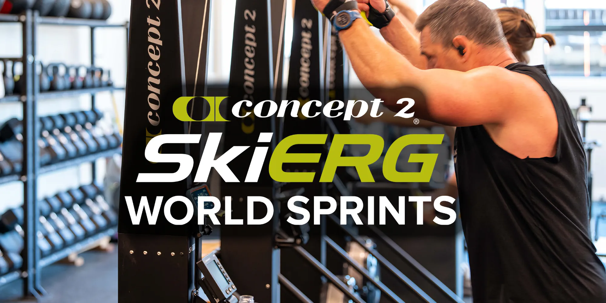 Side view of athlete mid-SkiErg sprint, explosive effort, gym lighting with shadows