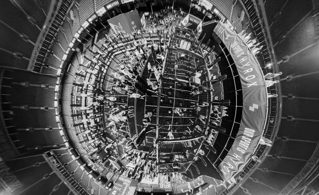 Overhead view of HYROX cardiff race hall showing multiple stations and spectators