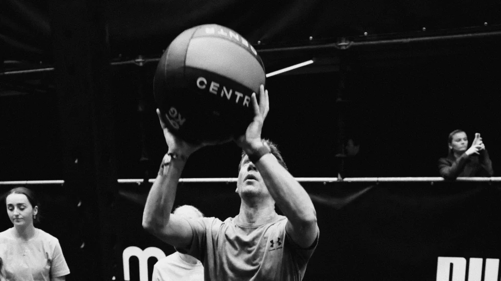 Athlete finishing wall balls during simulation, timer visible