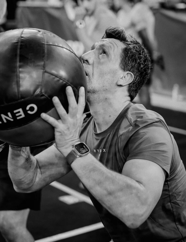 Athlete throwing wall ball at target, focus on breathing and rhythm