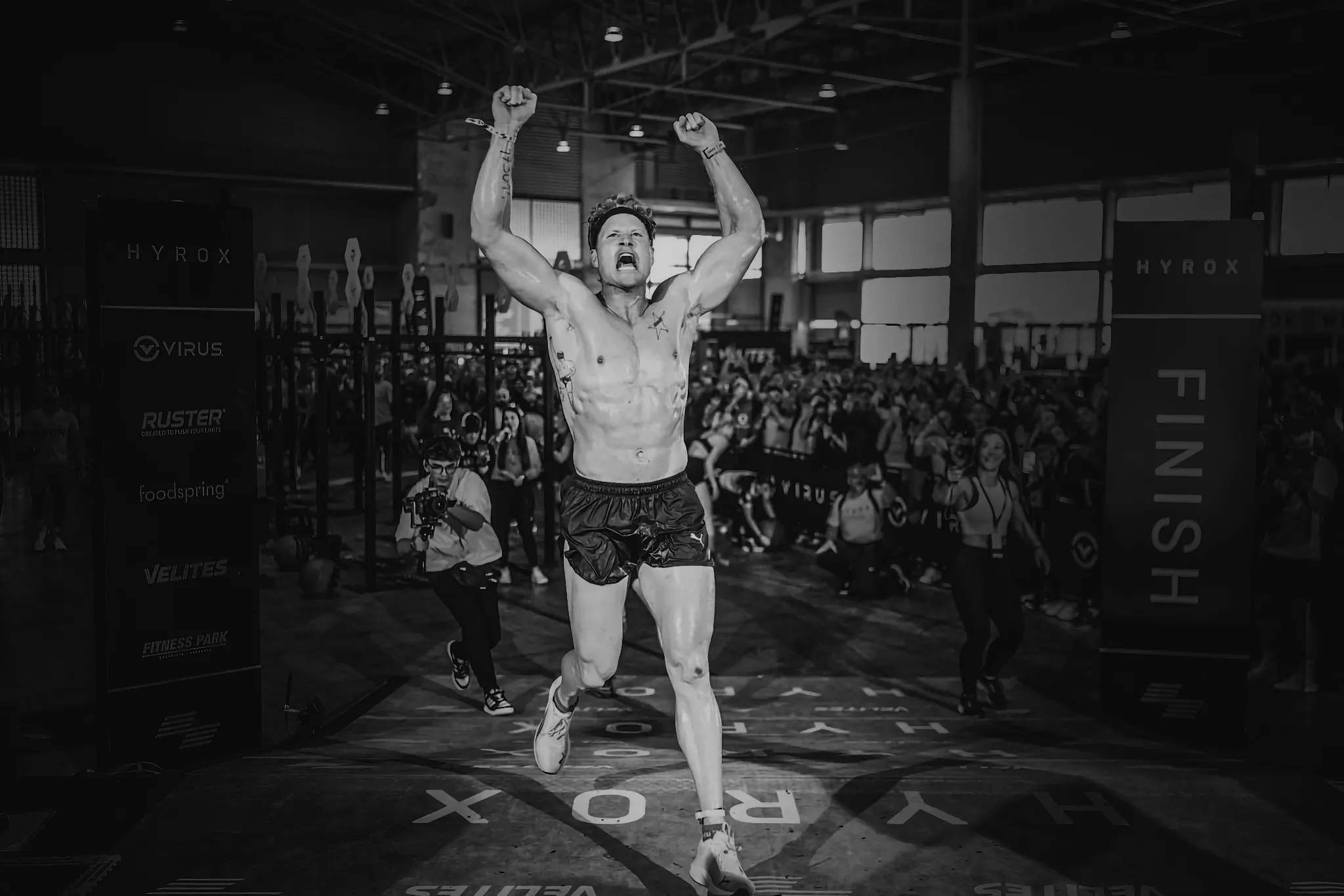 Hunter McIntyre finishing a HYROX race, powerful stride and focus