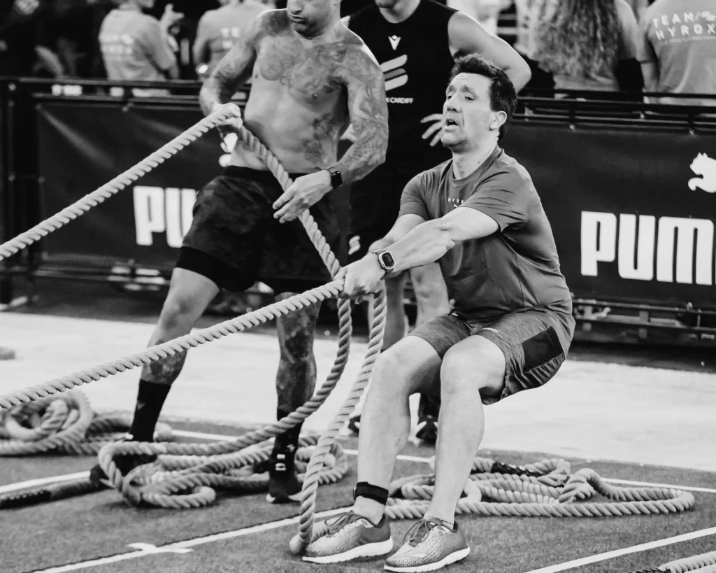 Athlete braced in seated position, rope taut between hands