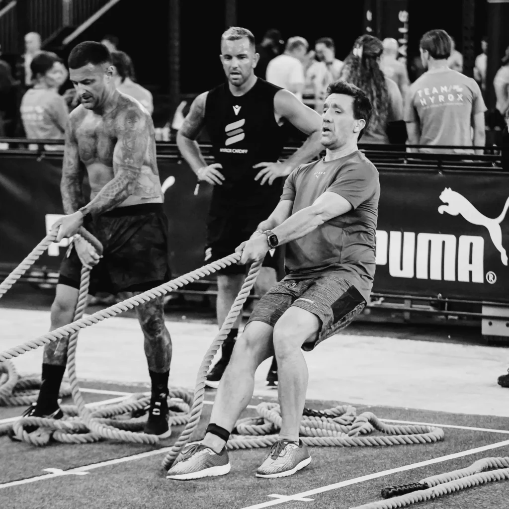 Side view of athlete mid-pull, rope tension visible