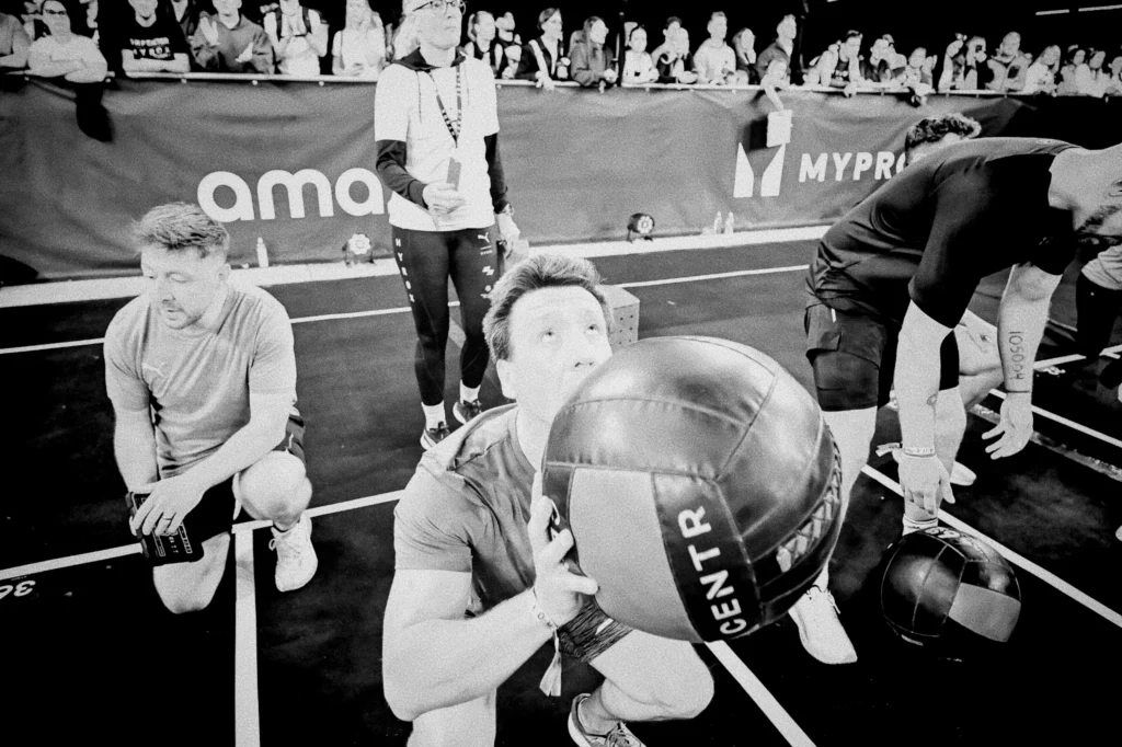 Athlete holding medicine ball in squat position before throw