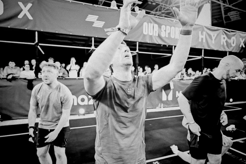 Athlete throwing wall ball to high target, full extension through hips