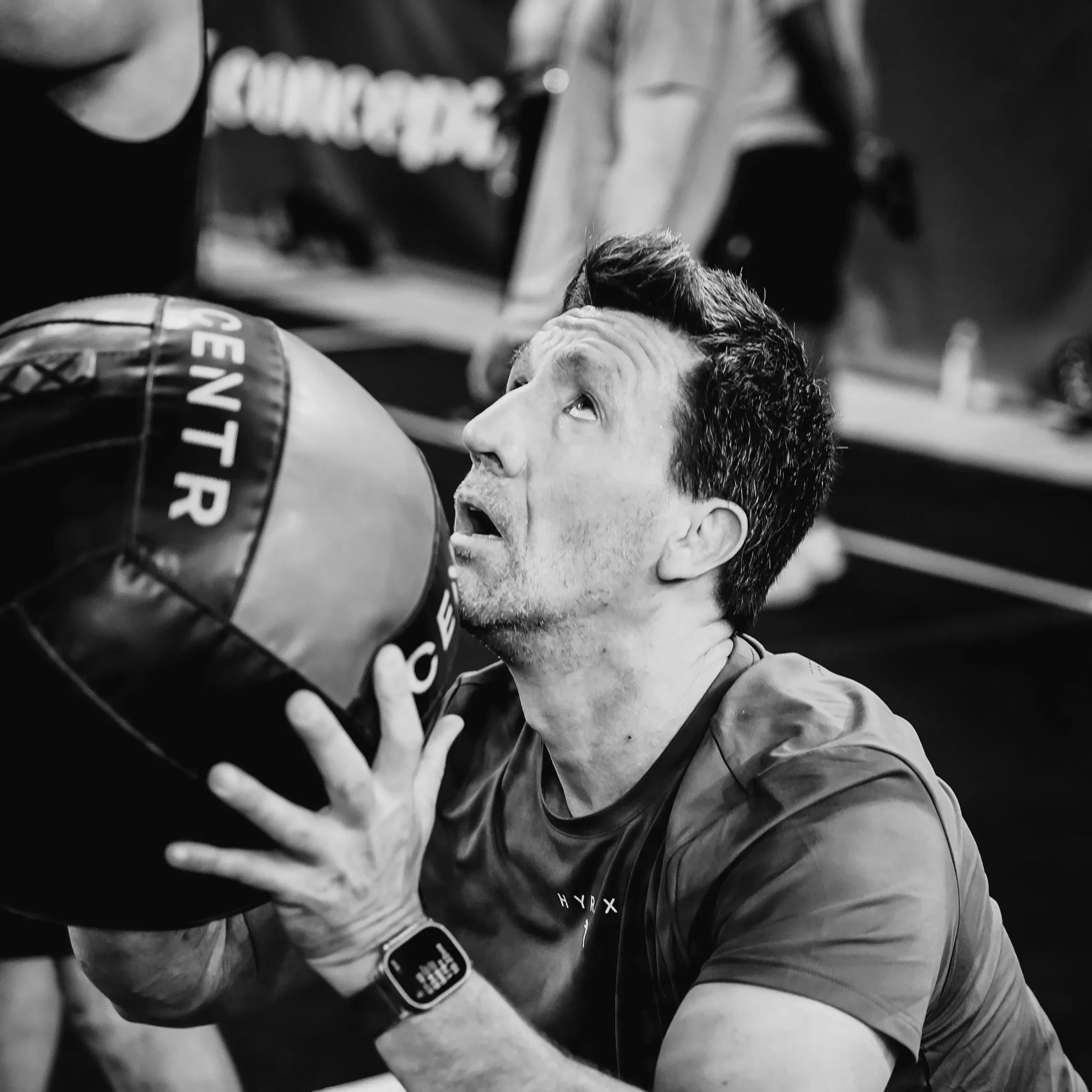 Athlete completing wall balls under fatigue, visible focus and effort