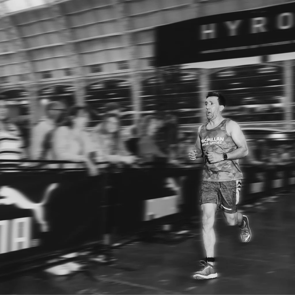 Athlete running between stations, visible fatigue but controlled breathing