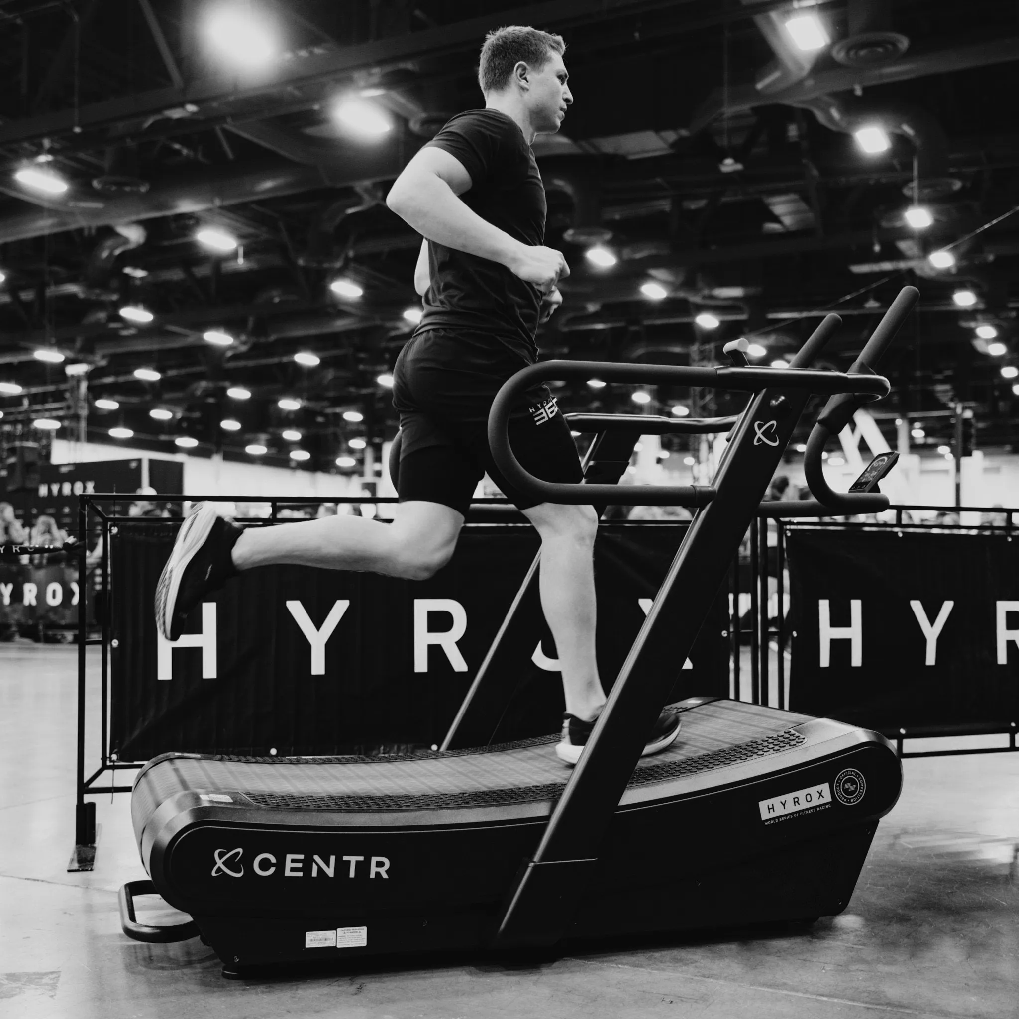 Athlete on curved treadmill at easy pace, calm breathing visible