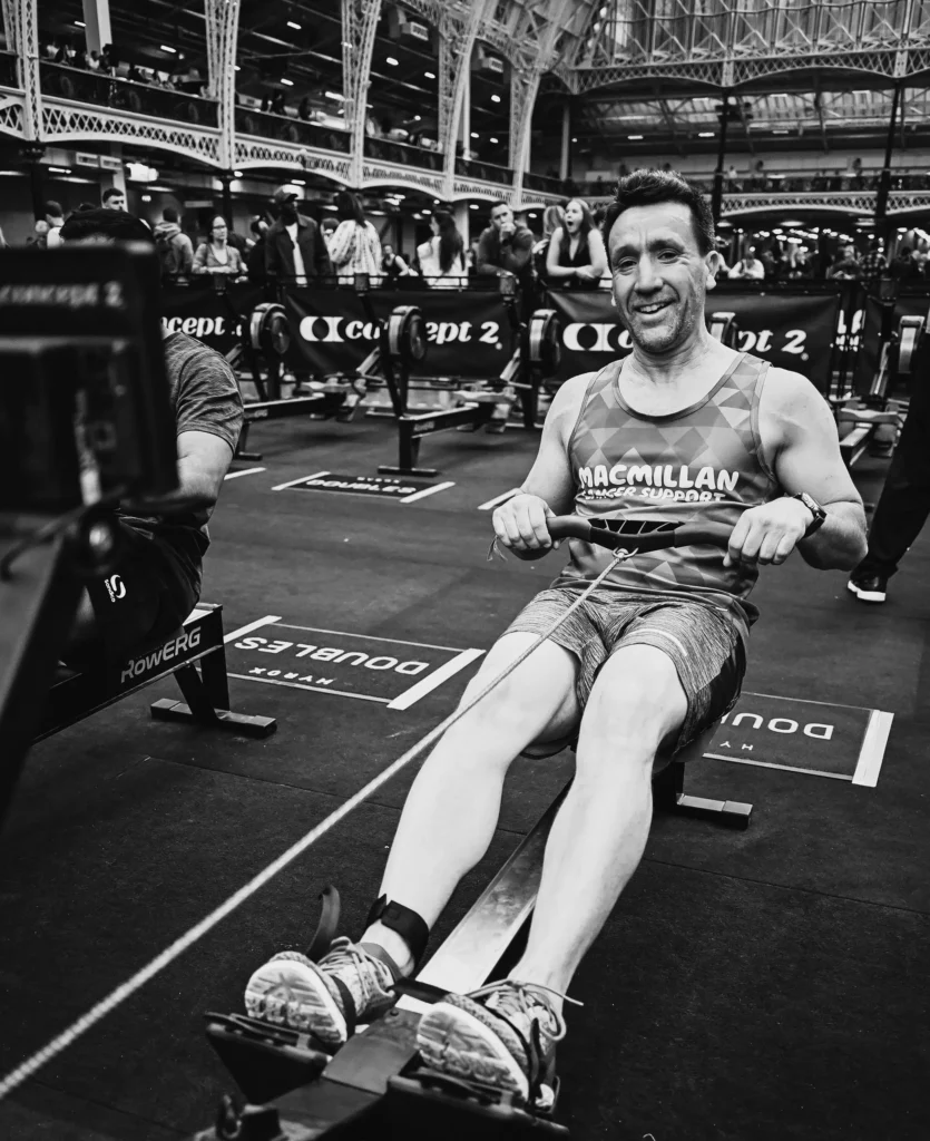 Athlete rowing mid-stroke with relaxed shoulders and strong leg drive