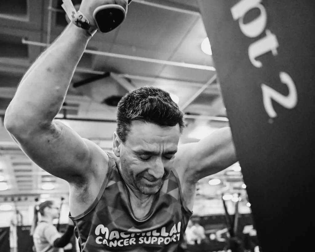 Athlete starting SkiErg pull with arms overhead, lats engaged, controlled posture