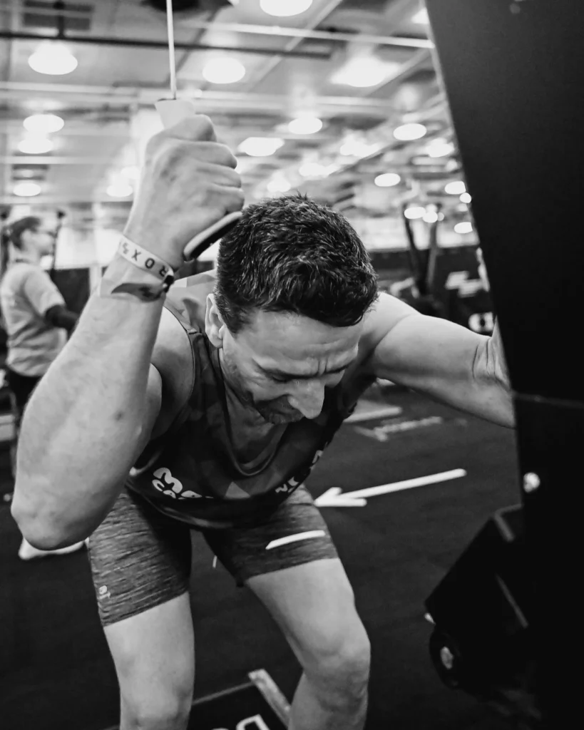 Athlete mid-drive showing strong hip hinge and lat contraction