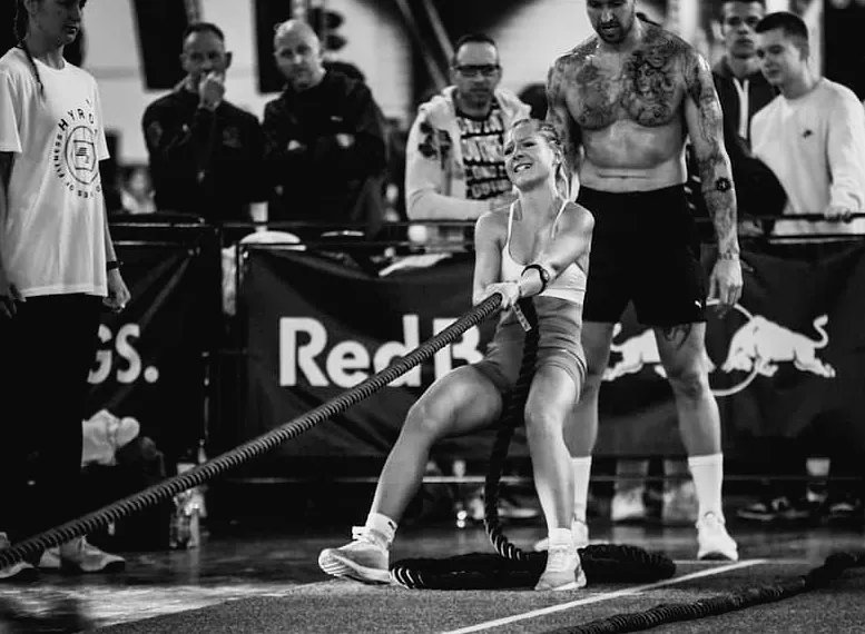 Two athletes fist tapping before entering a sled lane