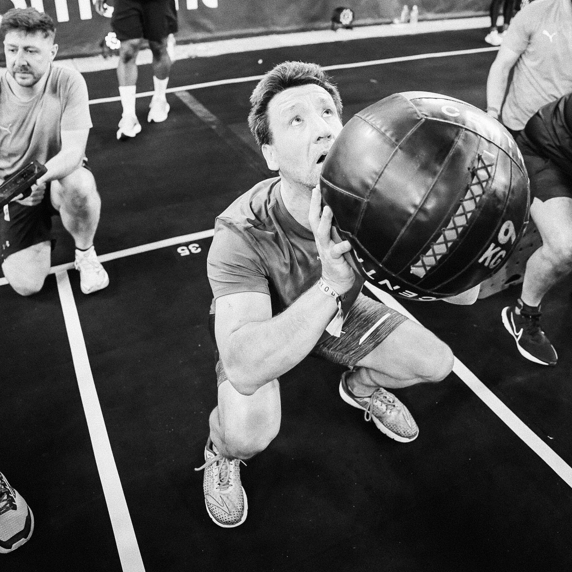 Two athletes alternating wall ball sets