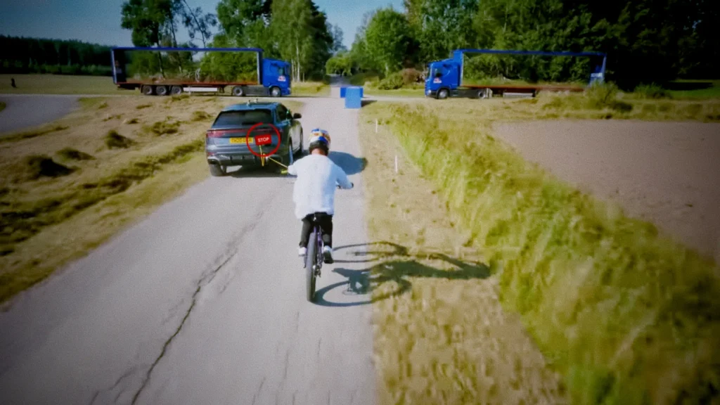matt jones mountain biker accelerating behind a towing car