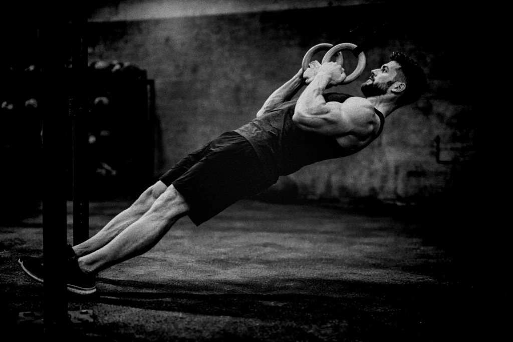 Side angle showing full-body alignment from heels to head with rings drawn to the chest