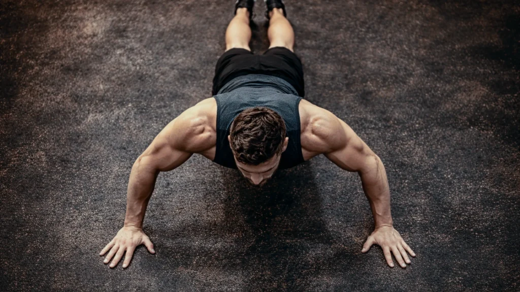Top-down view of a full lockout position in a push-up, straight line from heels to head. 2. Athlete midway through a hand-release, shoulders active