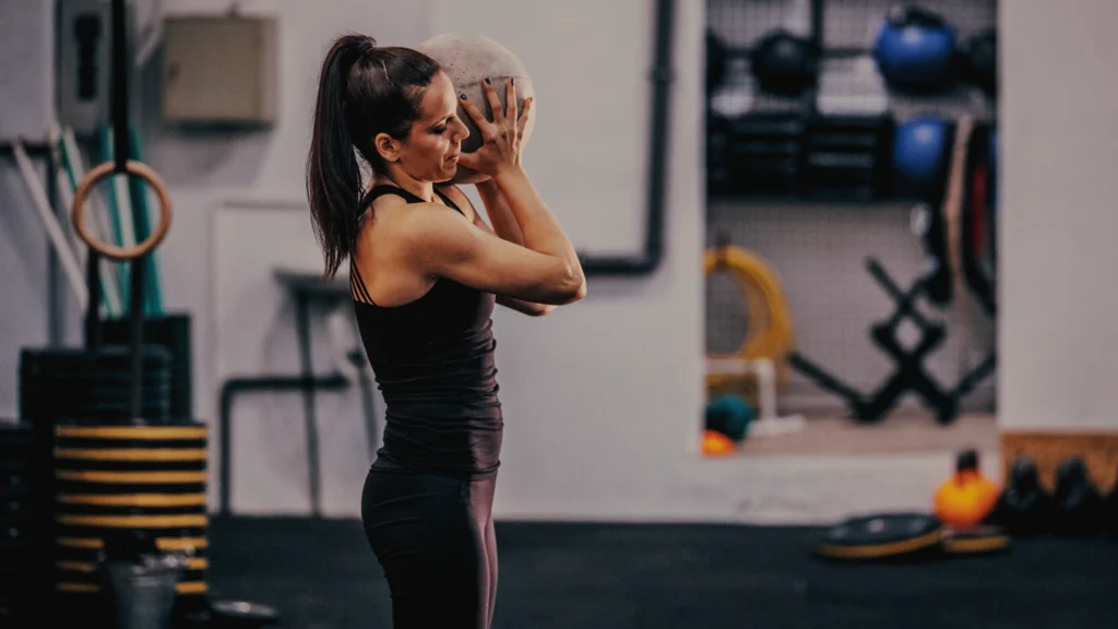 Athlete mid-shoulder toss with a heavy slam ball