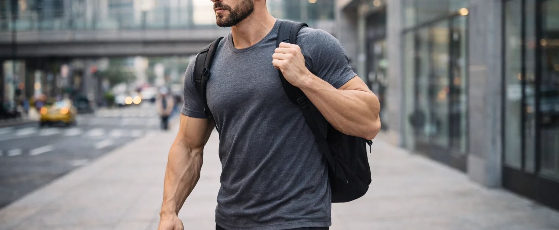 hybrid athlete walking through an urban environment carrying a backpack