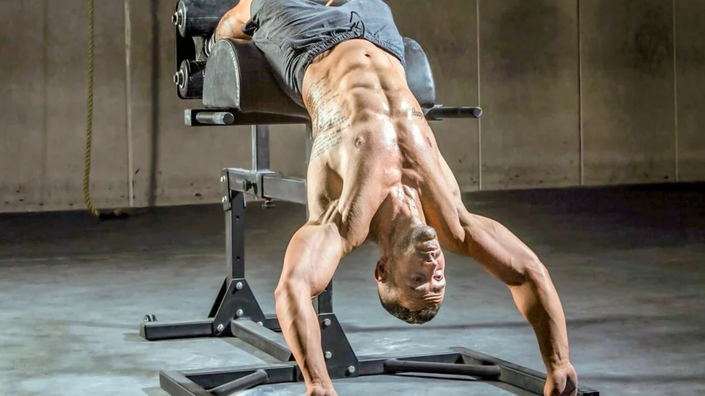 athlete performing a controlled GHD sit-up in a bright performance gym