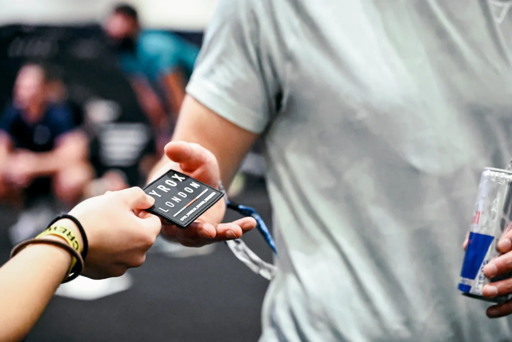 HYROX event volunteers assisting athletes after the race