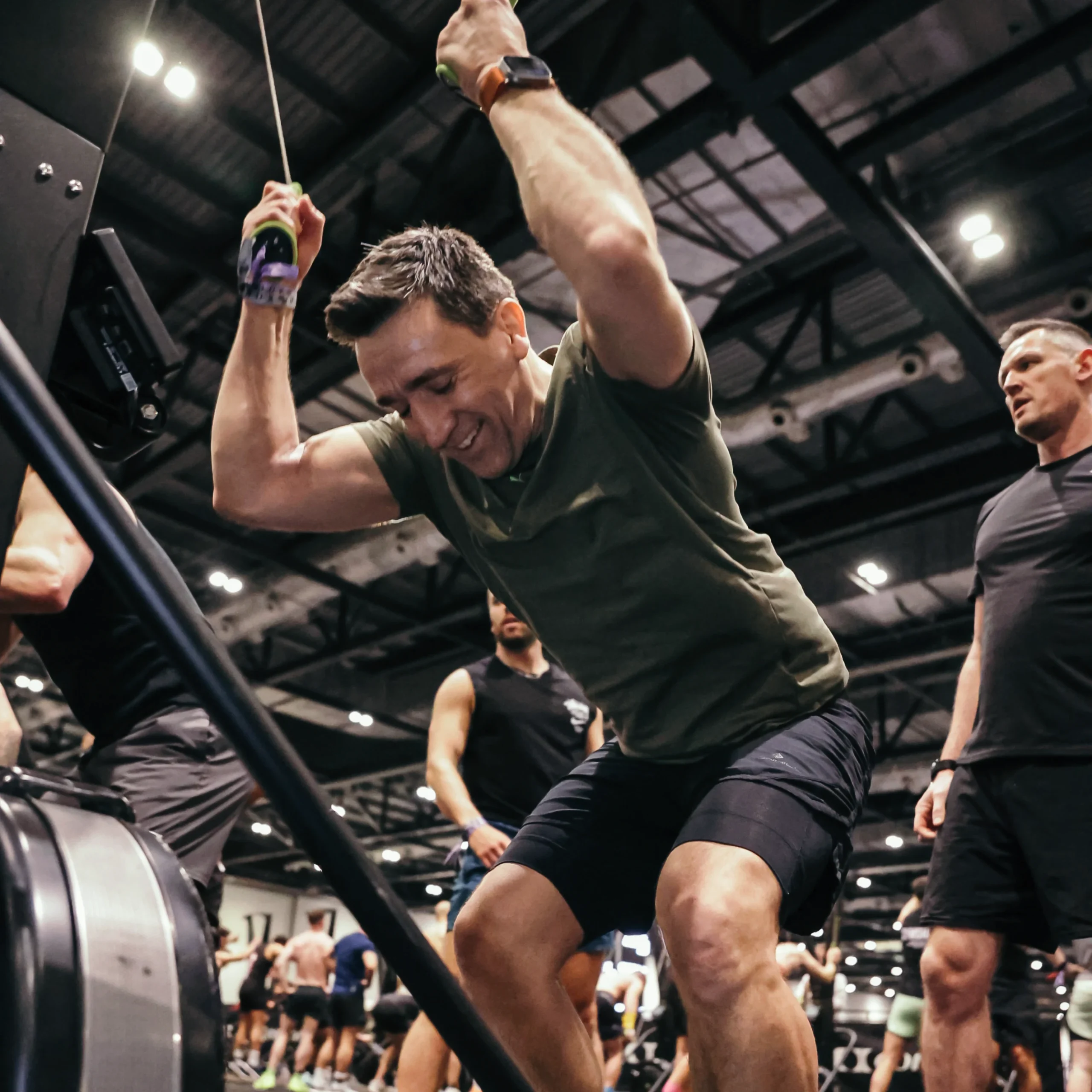 Athlete full flow on SkiErg, light sweat, focused expression