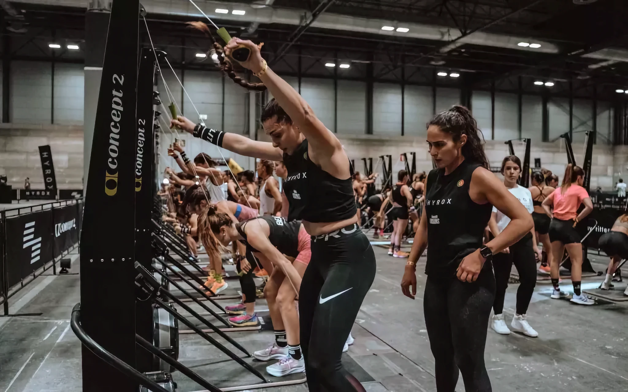 Athlete working steadily on a SkiErg during an interval, relaxed shoulders, rhythmic breathing
