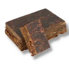 Samuel Gawith Grousemoor Plug loose pipe tobacco showing a dark pressed block of Virginia tobacco with a freshly cut slice revealing the densely layered leaf.