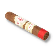Crowned Heads Mil Días Topes single loose cigar photographed diagonally against a white background, showing its medium-brown Ecuadorian Habano wrapper, ornate cream and gold band with red Crowned Heads emblem, separate Mil Días band and bright red ribbon