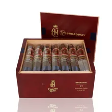 Open burgundy wooden presentation box of 21 Crowned Heads Broadway Robusto Extra cigars, showing individually sleeved dark brown cigars with ornate red and gold Crowned Heads bands, separate Broadway bands and navy-blue foot ribbons.