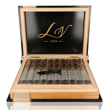 Open black lacquered Las Villas By the Book Toro presentation box containing 20 individually cellophane-wrapped cigars, showing black and gold Las Villas bands, white signature-printed sleeves, black foot ribbons