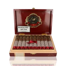Open burgundy lacquered Las Villas Selección cigar box containing 20 Box Pressed Robustos in two rows, with dark brown wrappers, ornate black and gold cigar bands, white signature-printed sleeves, red foot ribbons, a central crimson securing ribbon