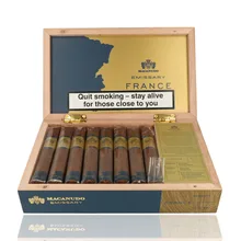 Open box of 16 Macanudo Emissary France Robusto cigars with branded presentation, information card and individually cellophaned cigars displayed inside.