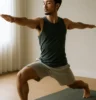Athlete mid-flow in yoga, martial arts, or slow-motion strength work, with serene expression and soft natural light.