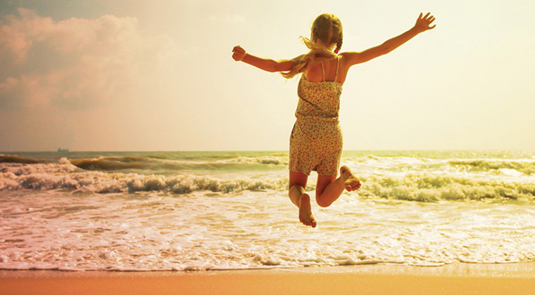 jumping for joy on the beach