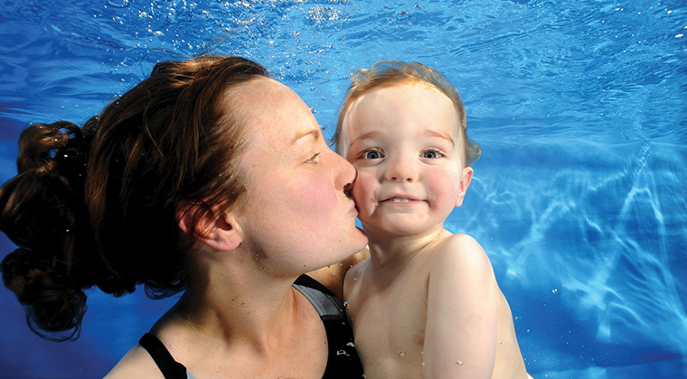 woman and baby swimming