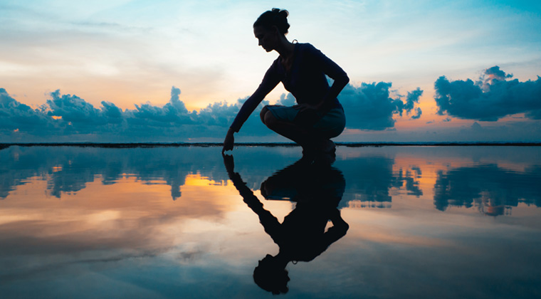 Silhouette of Women and shadow reflected in water