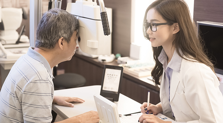 old man with optometrist in the store
