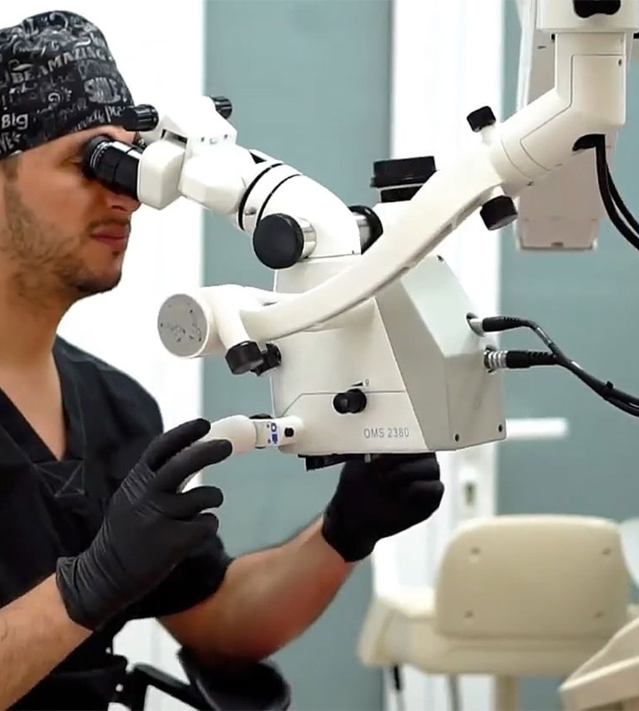 Person looking into a microscope during surgery
