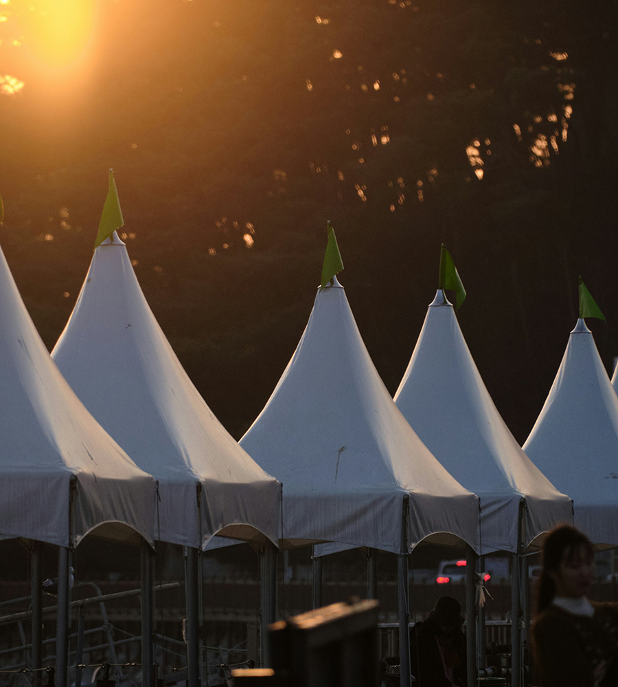 row of event tents with sunset