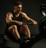 Athlete performing rowing machine intervals, with visible muscle engagement and dynamic movement