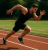 Sprinter launching off the start line or mid-stride on a track, muscles engaged and motion blurred for dramatic effect