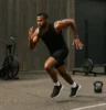 Athlete running or strength exercises in an outdoor or industrial gym setting, showcasing versatility and intensity.